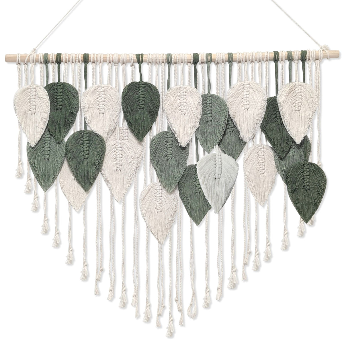 A hand-knotted macramé wall hanging featuring woven leaf shapes in white and green, suspended from a light wood dowel with a hanging string.